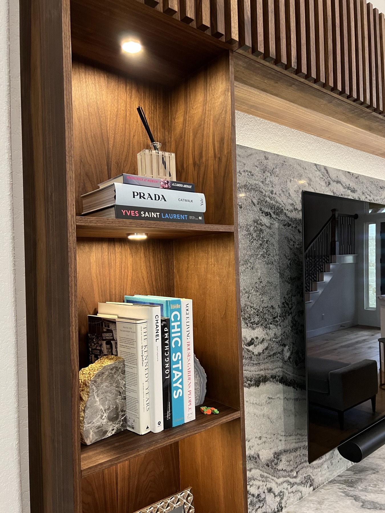 Walnut media wall shelving and stone detail